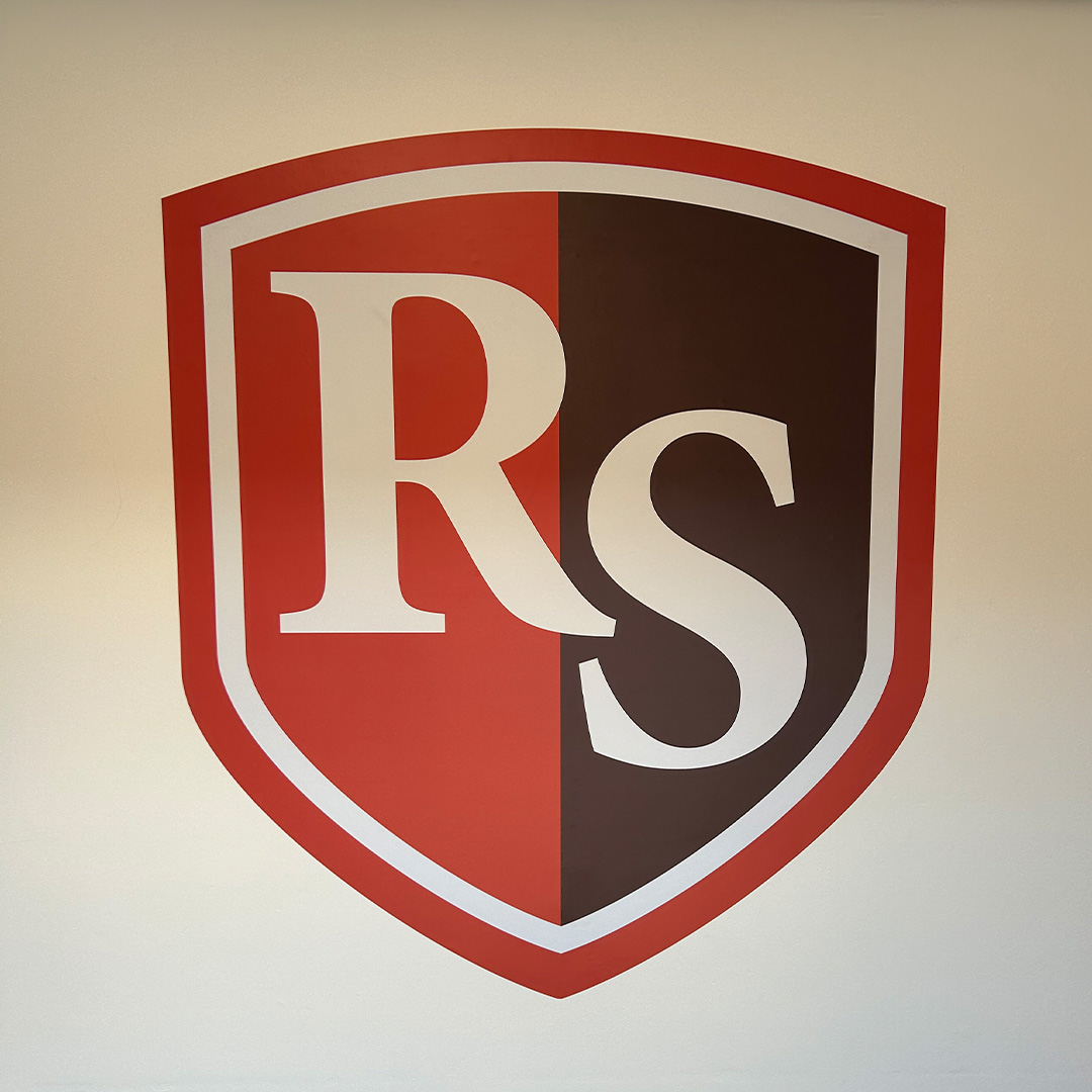 Rudheath Senior Academy Logo Design and Wall Branding RS shield logo painted on wall in red, white and dark maroon for Rudheath Senior Academy