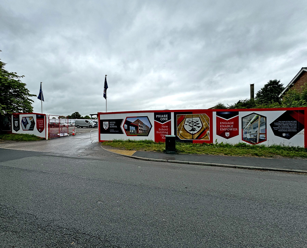 Deyes High School Site Hoarding Design – Lydiate Learning Trust Deyes High School hoarding panels with red and black branding around construction site