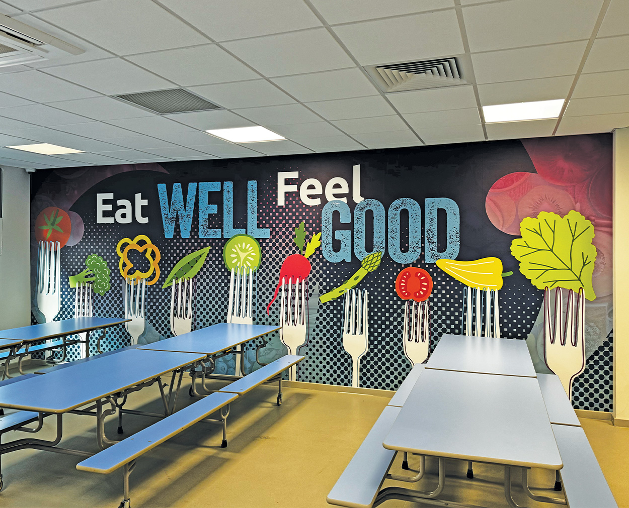 School Dining Hall Wall Graphics – Eat Well Feel Good Design Eat Well Feel Good dining hall wall graphics with illustrated vegetables on forks
