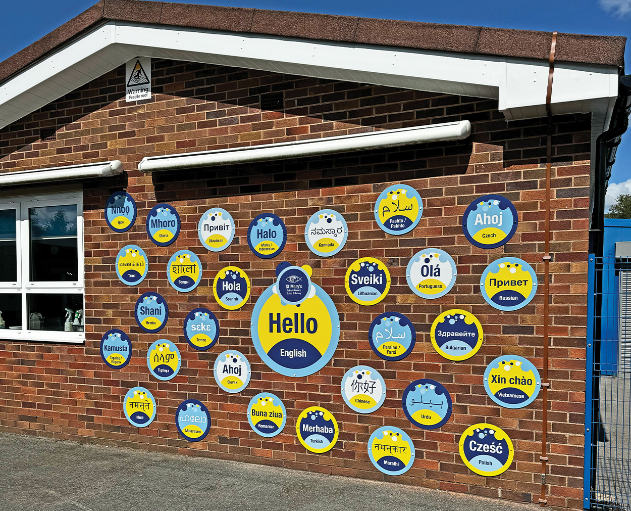 Multilingual Welcome Signage – St Mary’s Catholic Primary School St Mary's Catholic Primary School wall signs showing Hello translated into multiple languages