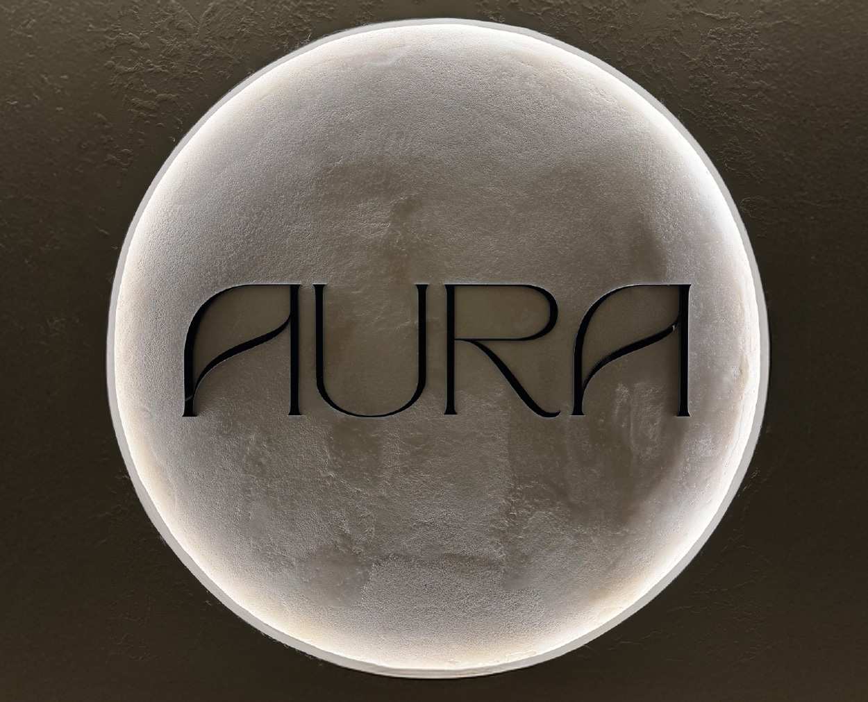 Aura Logo Illuminated Aura sign with backlit circular logo design