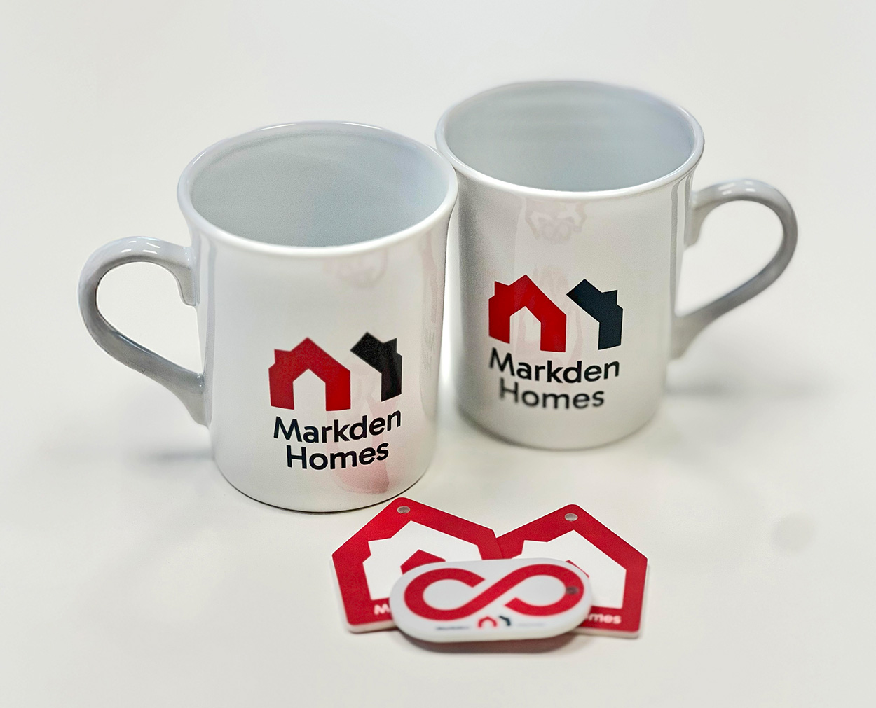 Markden Homes Branded Merchandise Markden Homes branded mugs and keyrings with red and black logo design